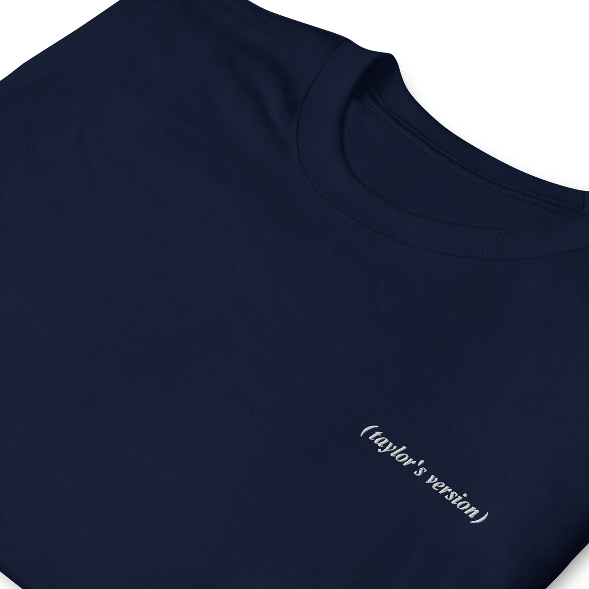 Close-up of a navy t-shirt with "(taylor's version)" embroidered in script text