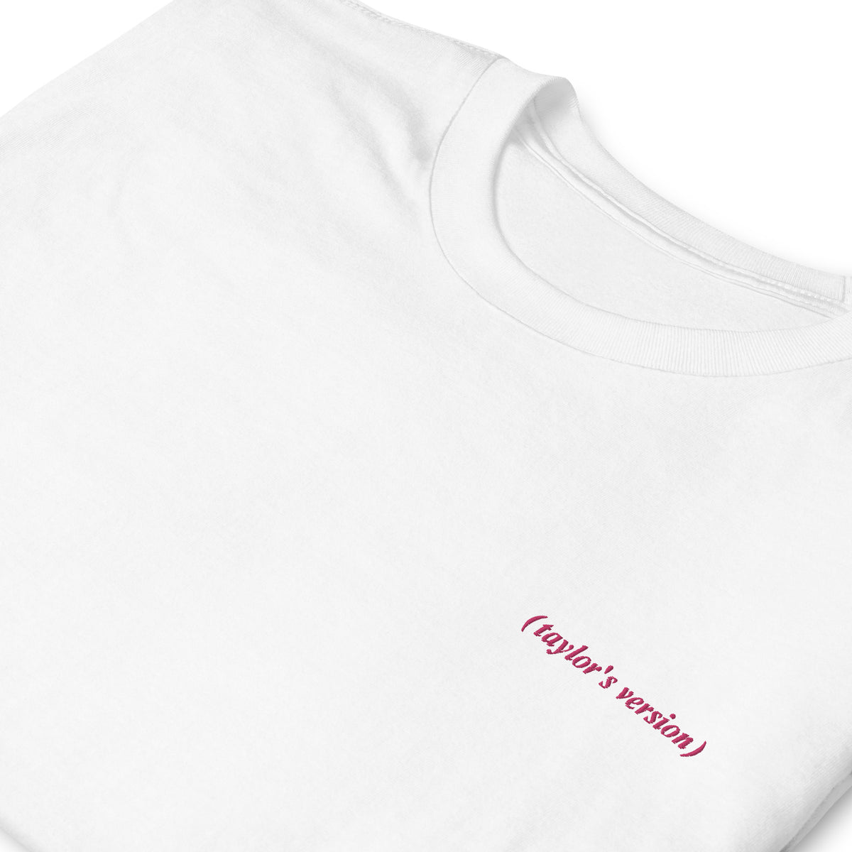 Close-up of a white t-shirt with "(taylor's version)" embroidered in script text